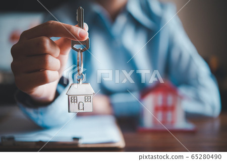 Salesperson Holding house keys concept, house keys 65280490
