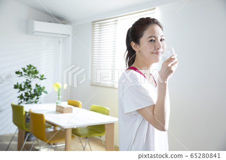 A woman exercising in the living room A woman exercising in the living room 65280841