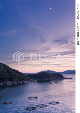The townscape of the crescent moon and the boat house in the evening sky of Ine Bay, Kyoto The townscape of the crescent moon and the boat house in the evening sky of Ine Bay, Kyoto 65282367