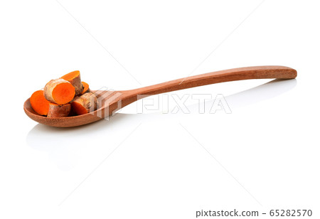 Turmeric in a wooden spoon on a white background Turmeric in a wooden spoon on a white background 65282570