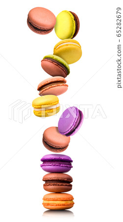 Set of flying french colorful macaroons isolated on white background 65282679