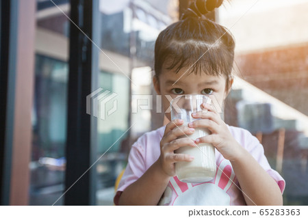 Cute asian little child girl drinking milk 65283363
