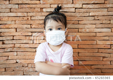 Asian little child girl wearing protection mask stay at home to protect the coronavirus Covid-19 65283365
