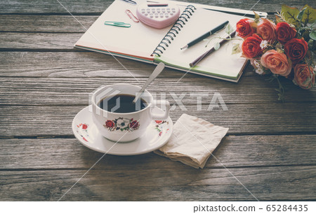 Vintage Film Look: cup of coffee with notebook 65284435
