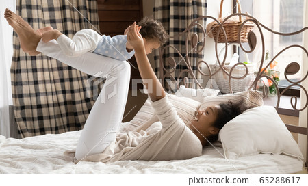 Happy biracial mom playing with little baby Happy biracial mom playing with little baby 65288617