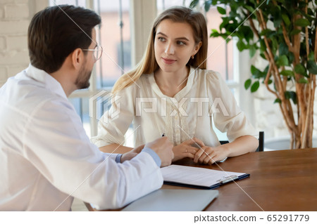 Male doctor consult female patient in hospital Male doctor consult female patient in hospital 65291779