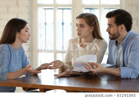 Angry couple argue with realtor about contract rules Angry couple argue with realtor about contract rules 65291893