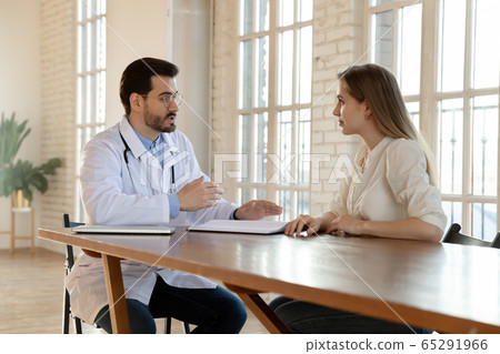 Male doctor talk consult female patient in hospital Male doctor talk consult female patient in hospital 65291966
