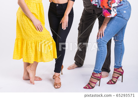 Couple dancing latin music. Bachata, merengue, salsa and kizomba. Close-up of legs dancers on white room. Couple dancing latin music. Bachata, merengue, salsa and kizomba. Close-up of legs dancers on white room. 65293571