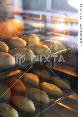 Raw pies on pan sheets in oven Raw pies on pan sheets in oven 65294044