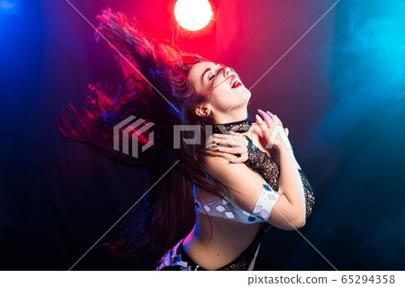 Spirituality dance. Beautiful sexy woman with luxury glossy eastern make-up dancing tribal fusion. Belly dance. 65294358