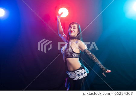 Spirituality dance. Beautiful sexy woman with luxury glossy eastern make-up dancing tribal fusion. Belly dance. Spirituality dance. Beautiful sexy woman with luxury glossy eastern make-up dancing tribal fusion. Belly dance. 65294367