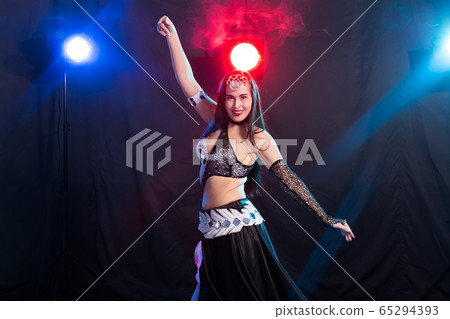 Spirituality dance. Beautiful sexy woman with luxury glossy eastern make-up dancing tribal fusion. Belly dance. 65294393