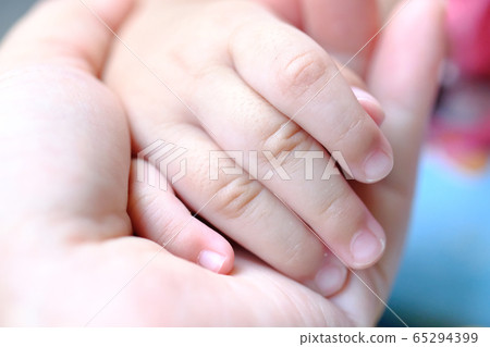 Hands of mother and baby closeup. Concept of love and family. 65294399