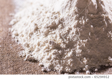 Heap of dry flour on textile. Cooking flour products concept. Heap of dry flour on textile. Cooking flour products concept. 65294912