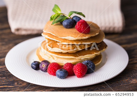 Close-up delicious pancakes with fresh blueberries and raspberries. Close-up delicious pancakes with fresh blueberries and raspberries. 65294953