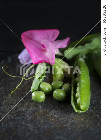 Garden peas on a black slate plate Garden peas on a black slate plate 65295226