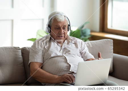 Modern senior man talk on video call on laptop Modern senior man talk on video call on laptop 65295342