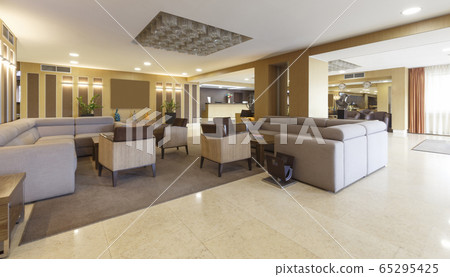 Gray sofas and armchairs in hotel lounge room Gray sofas and armchairs in hotel lounge room 65295425