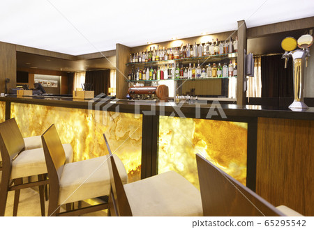 Futuristic hotel bar. Yellow-brown design with high chairs Futuristic hotel bar. Yellow-brown design with high chairs 65295542