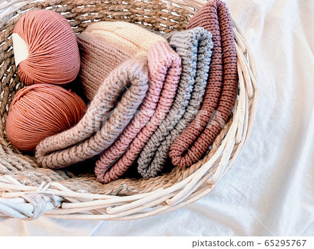 woolen knitted hats and balls of thread 65295767