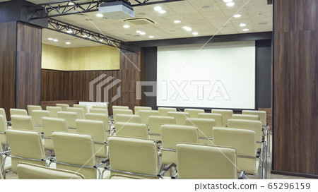 Auditorium with chairs and blank screen, panorama 65296159