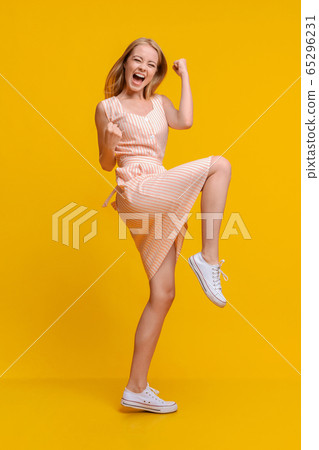 Lucky Win. Euphoric Teen Girl In Dress Emotionally Rejoicing Success 65296231