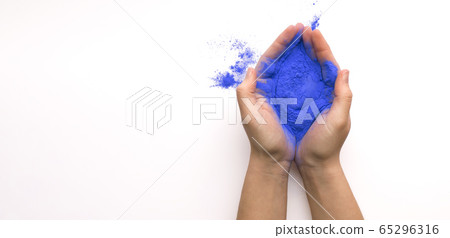 Blue paint for annual Holi celebration in hands Blue paint for annual Holi celebration in hands 65296316
