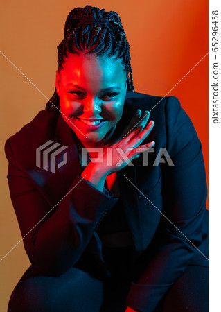 Close up portrait of Fashion young american African girl woman. Neon light. 65296438