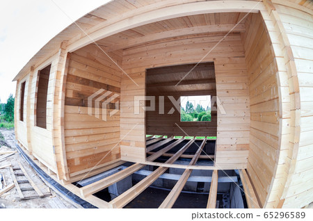 Construction of wooden house on the stone 65296589