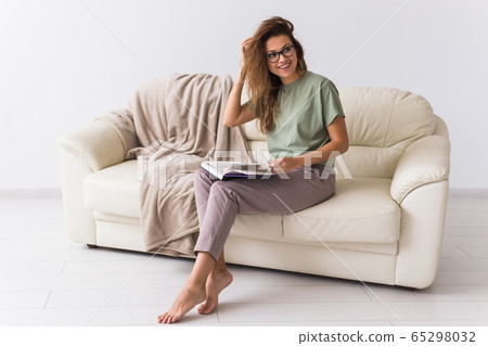 Beautiful girl read book. Concept of relaxation, slow life, hobby, home comfort. Social media, digital detox. Quarantine, self-isolation, social phobia. 65298032