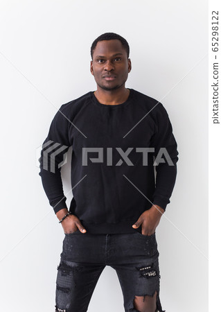 Youth street fashion concept - Portrait of confident sexy black man in stylish sweatshirt on white background. Youth street fashion concept - Portrait of confident sexy black man in stylish sweatshirt on white background. 65298122
