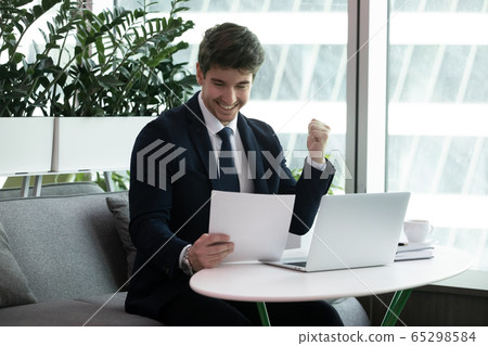 Businessman reading paper financial documentation feels excited 65298584