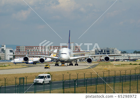 FRANKFURT, GERMANY - JUN 09th, 2017: Airbus A380 of Lufthansa with registration D-AIMH moves on taxiway by tow truck before departure from FRA airport 65298972