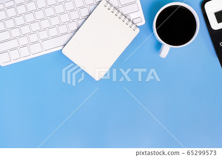 flat lay Office desk table of modern workplace with laptop on blue table, top view laptop background and copy space on black background 65299573
