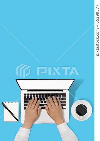businessman working with modern workplace with laptop on blue table, Man hand on laptop keyboard for work from home 65299577