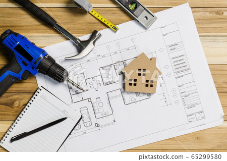 Architect workplace top view. Architectural project, blueprints, blueprint rolls on table. Construction background. Engineering tools. Copy space Architect workplace top view. Architectural project, blueprints, blueprint rolls on table. Construction background. Engineering tools. Copy space 65299580