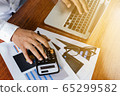 businessman working with modern workplace with laptop on wood table, Man hand on laptop keyboard for work from home 65299582