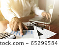 businessman working with modern workplace with laptop on wood table, Man hand on laptop keyboard for work from home 65299584