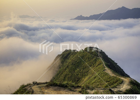 Ta Xua is a famous mountain range in northern Vietnam. All year round, the mountain rises above the clouds creating cloud inversions. Ta Xua is a famous mountain range in northern Vietnam. All year round, the mountain rises above the clouds creating cloud inversions. 65300869