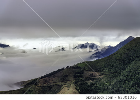 Ta Xua is a famous mountain range in northern Vietnam. All year round, the mountain rises above the clouds creating cloud inversions. Ta Xua is a famous mountain range in northern Vietnam. All year round, the mountain rises above the clouds creating cloud inversions. 65301016