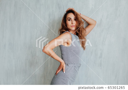 Portrait of a fashionable woman in a gray stylish dress Portrait of a fashionable woman in a gray stylish dress 65301265