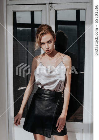 Portrait of a beautiful woman blonde in business clothes at work in a business office Portrait of a beautiful woman blonde in business clothes at work in a business office 65301366