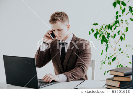 a man works in the Office at the computer business clerk a man works in the Office at the computer business clerk 65301618