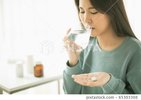 Young woman ill ill physical condition bad medicine drinking water person material Young woman ill ill physical condition bad medicine drinking water person material 65303308