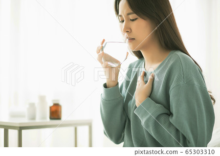 Young woman ill ill physical condition bad medicine drinking water person material Young woman ill ill physical condition bad medicine drinking water person material 65303310