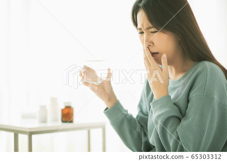 Young woman ill ill physical condition bad medicine drinking water person material Young woman ill ill physical condition bad medicine drinking water person material 65303312