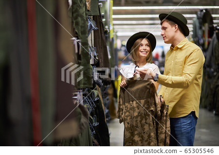 beautiful married couple going to go in mountains, shopping in sportive wear store beautiful married couple going to go in mountains, shopping in sportive wear store 65305546
