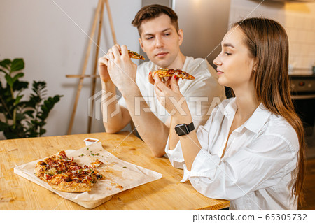 married couple ordered pizza at home married couple ordered pizza at home 65305732
