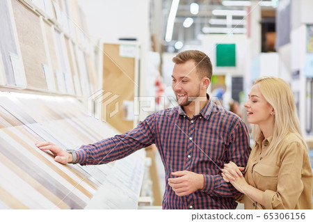 young caucasian couple looking for the most suitable commodity in the market 65306156